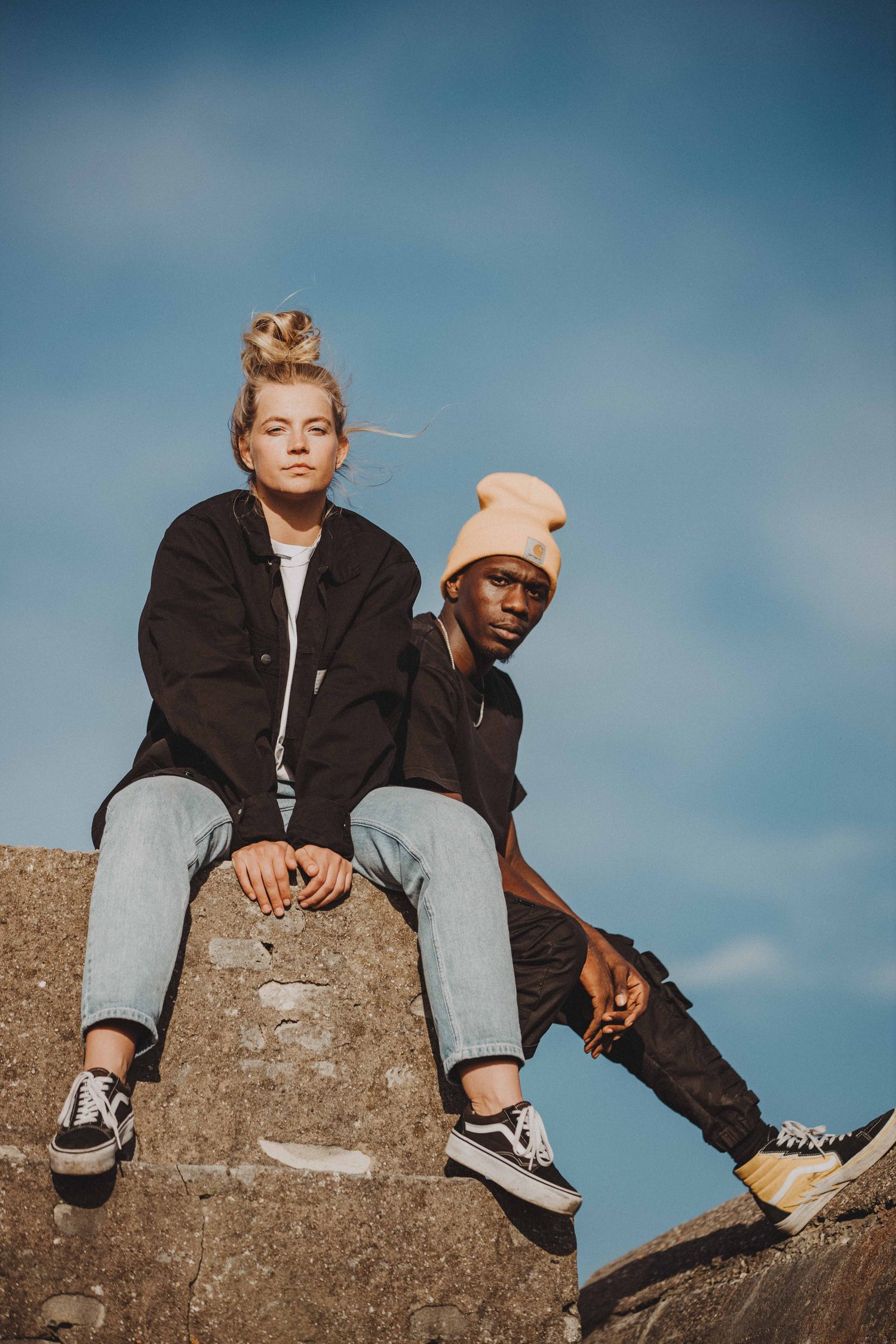 Two models sitting on top of a concrete bunker against the sky
