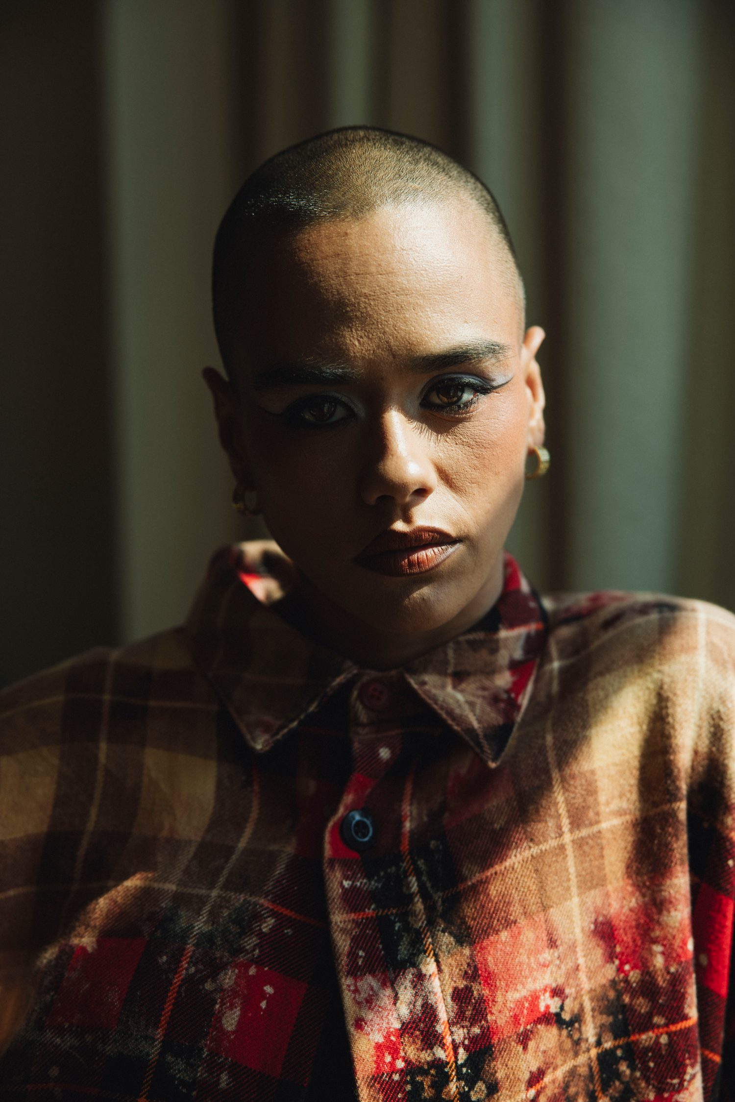 Close-up portrait of a model in a plaid shirt